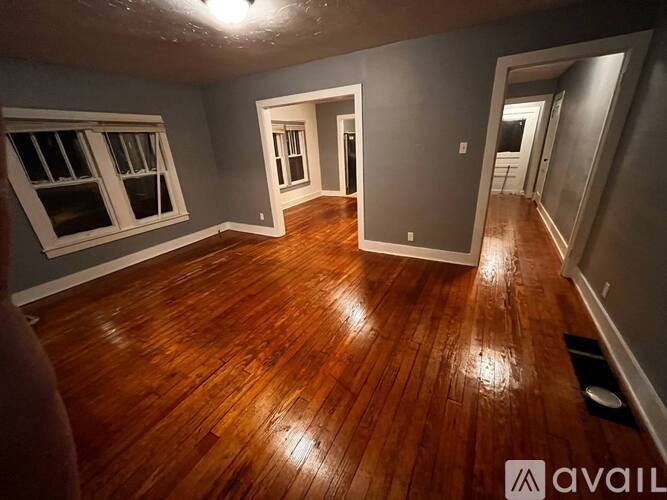 A room with wooden floors and a window.