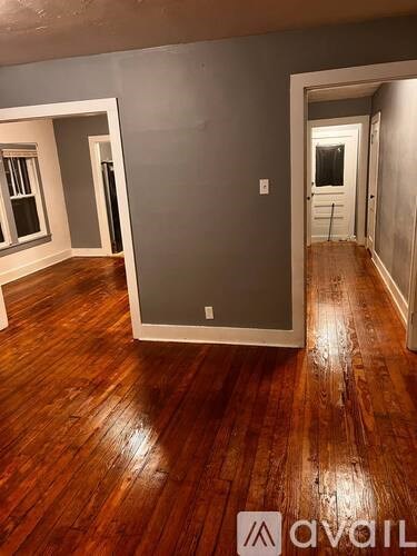 A room with wooden floors and a window.