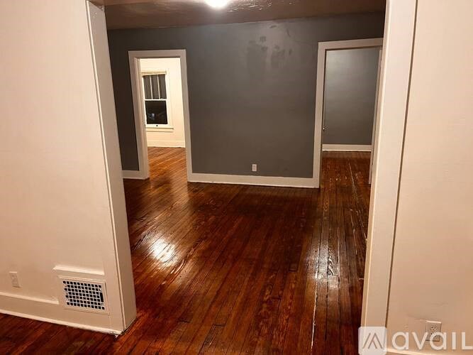 A room with wooden floors and a window.