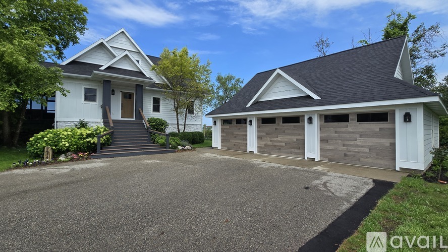 A two-story house with a garage is available for sale.