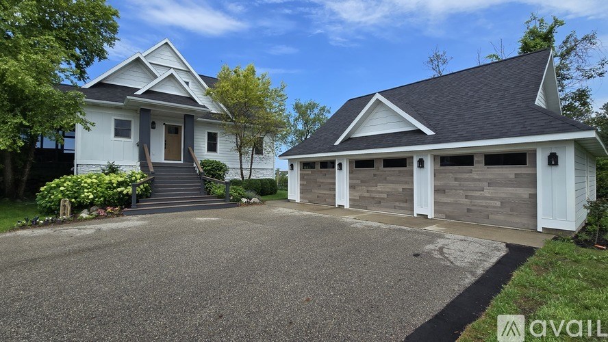 A two-story house with a garage is available for sale.
