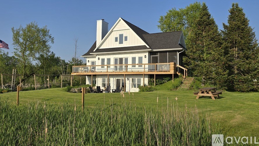 A large house with a flag on the lawn.