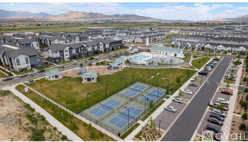 A large residential complex with a swimming pool and solar panels.