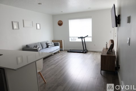A living room with a grey sofa and a wooden coffee table.