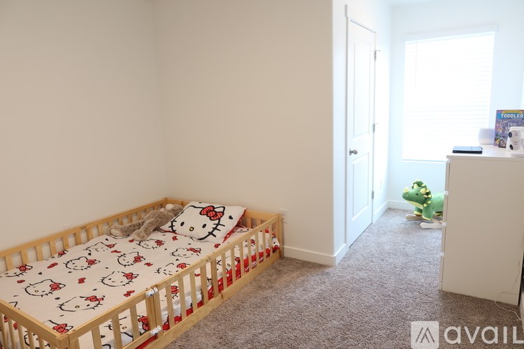 A small child's bedroom with a Hello Kitty bedspread.