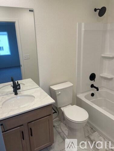 A bathroom with a toilet, sink, and bathtub.