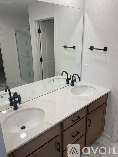 A bathroom with a marble countertop and two sinks.