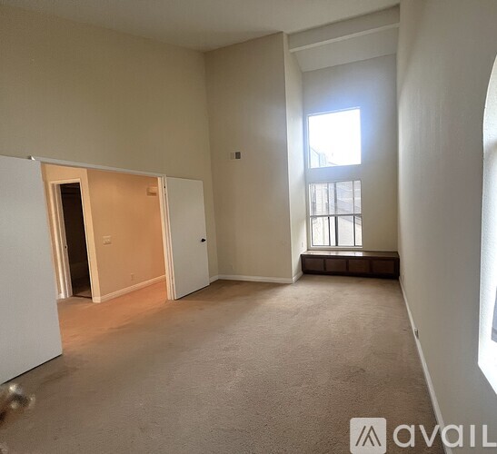 A room with a window and a bench in it.