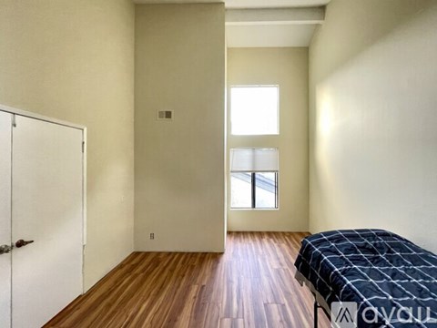 A room with a window and a bench in it.