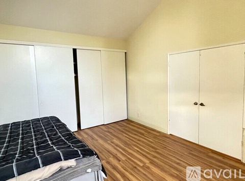 A room with a carpeted floor and a window with a white frame.