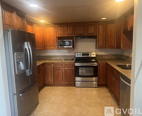 A kitchen with wooden cabinets and stainless steel appliances.