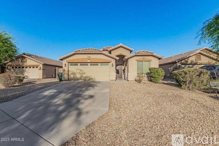 A sunny day in a neighborhood with houses and a clear blue sky.