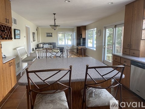 A kitchen with a table and chairs in the foreground.