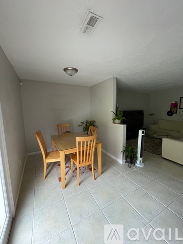 A dining room with a table and chairs.
