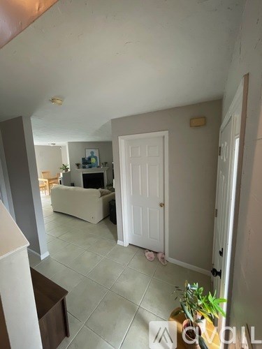 A living room with a white couch and a white door.