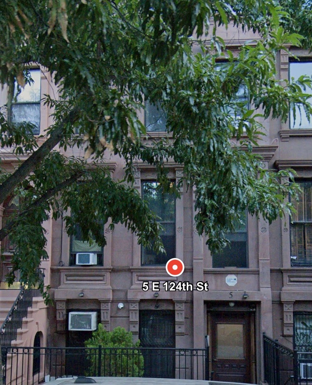 A brown building with the number 5E124th St on it.