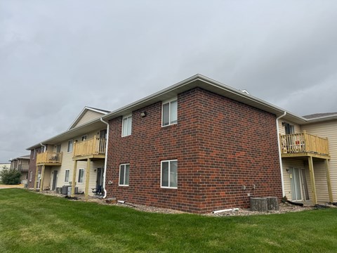 A red brick building with a balcony on the second floor.