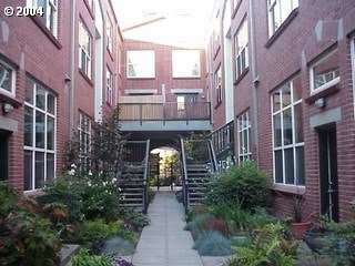A courtyard with a staircase surrounded by red brick buildings.