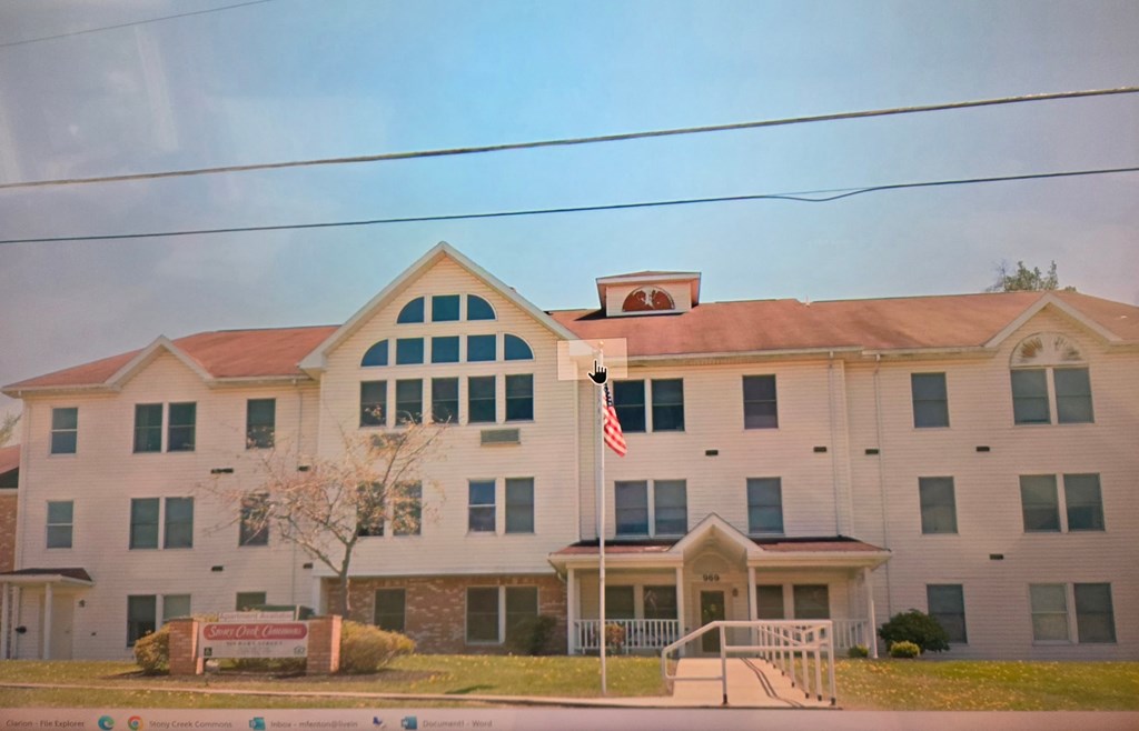 A white building with a red roof and an American flag on top.