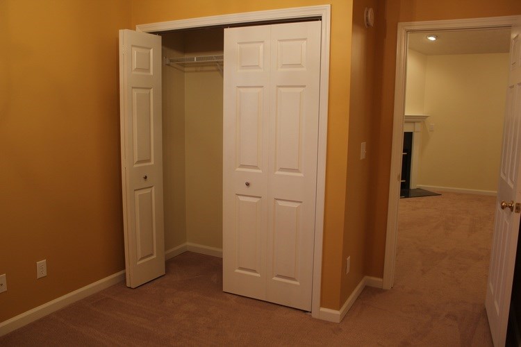 A white door is open to a hallway.