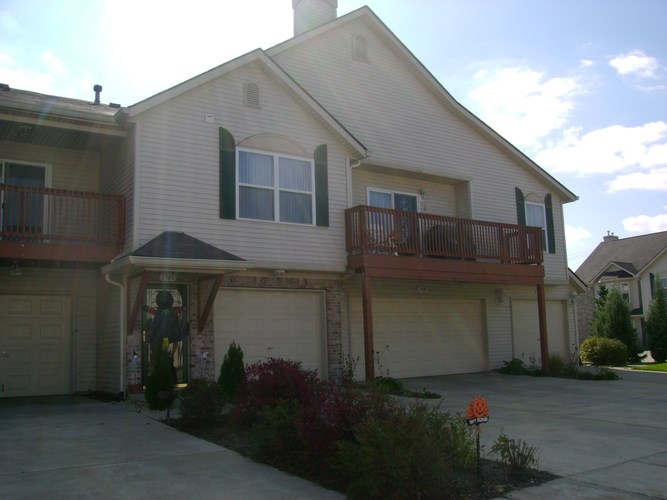 A house with a balcony and a garage.
