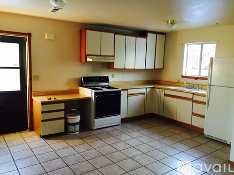 A kitchen with a white refrigerator, a stove, and a dishwasher.