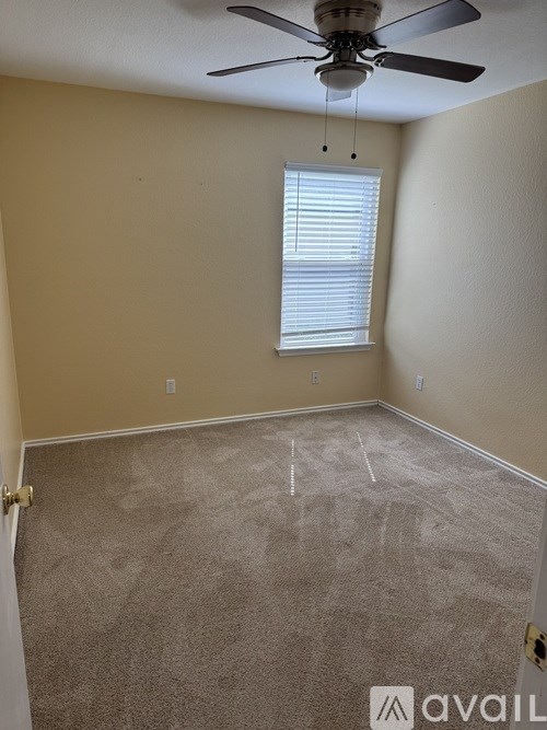 A bedroom with a bed, dresser, and window.