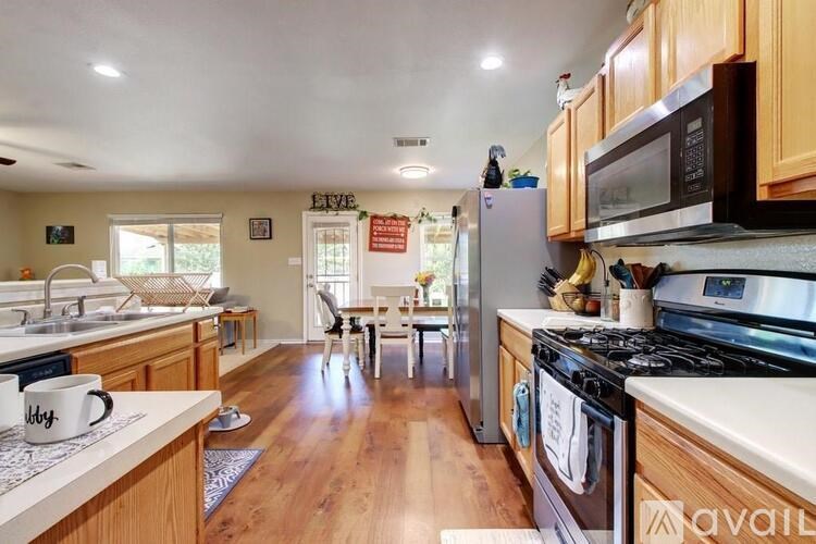 A kitchen with wooden cabinets and a black stove top oven.