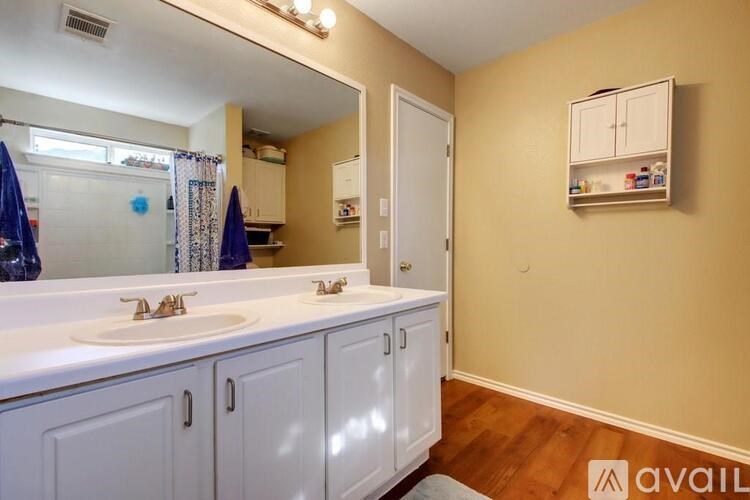 A bathroom with two sinks and a large mirror.
