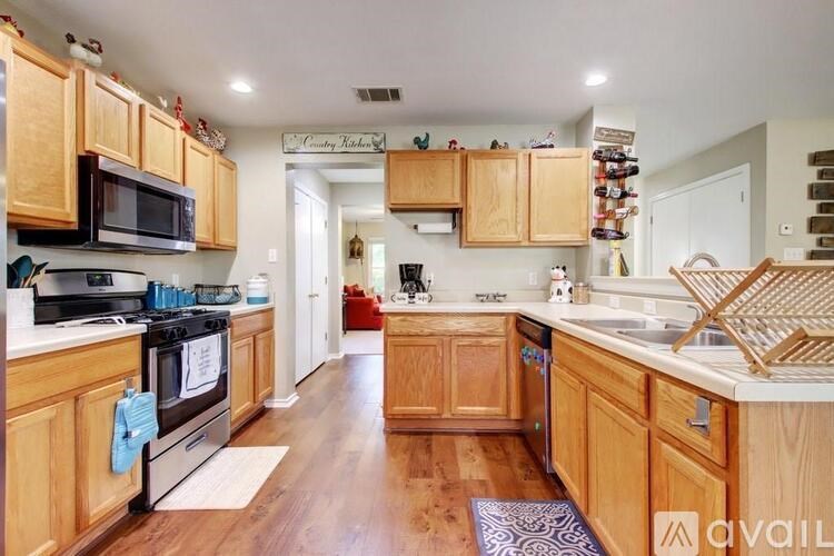 A kitchen with wooden cabinets and a black stove top oven.