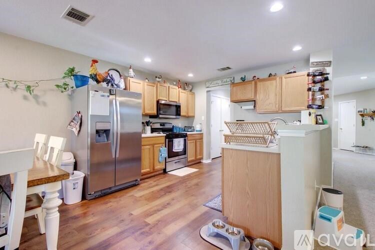 A kitchen with wooden floors and a refrigerator.