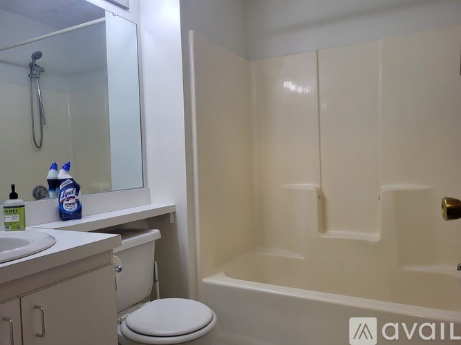 A bathroom with a toilet, sink, and bathtub.