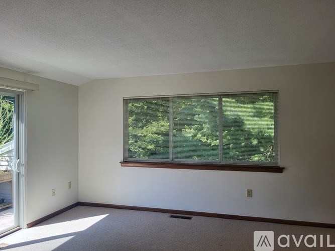 A room with a window and a door leading outside.