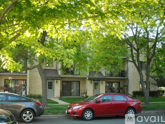 A red car is parked in front of a house.