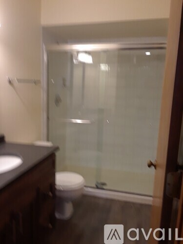 A bathroom with a toilet, sink, and shower.