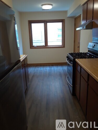 A kitchen with wooden floors and a window.