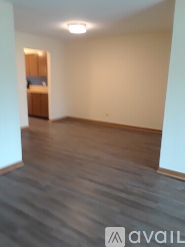 A room with a grey floor and a white wall.