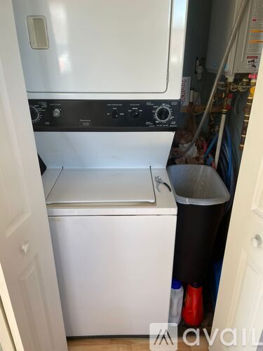 A white dishwasher is in a small kitchen.