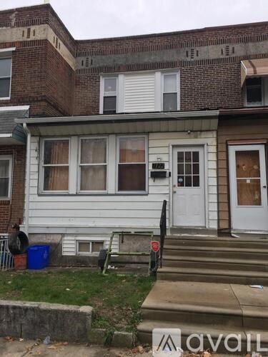 A two-story house with a white door and windows.