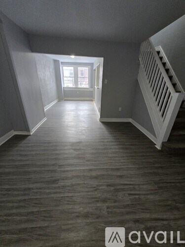 A room with wooden floors and a window.
