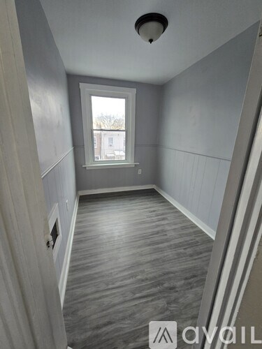 A room with grey walls and a window.