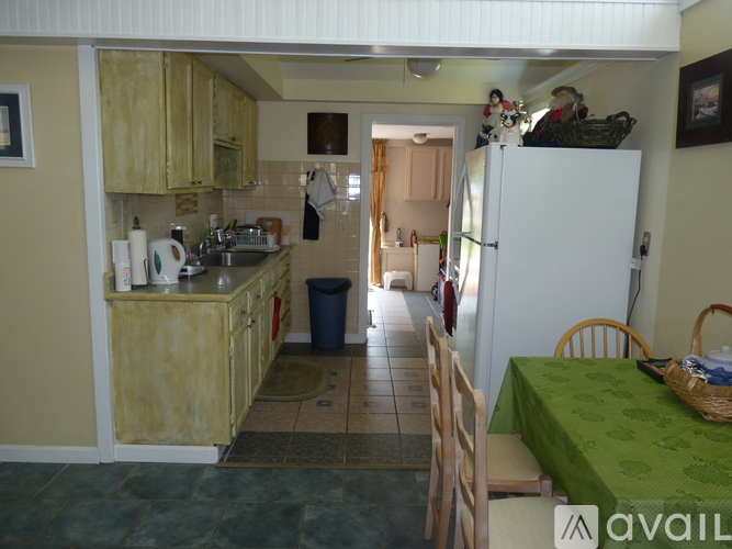A kitchen with a table and chairs in it.
