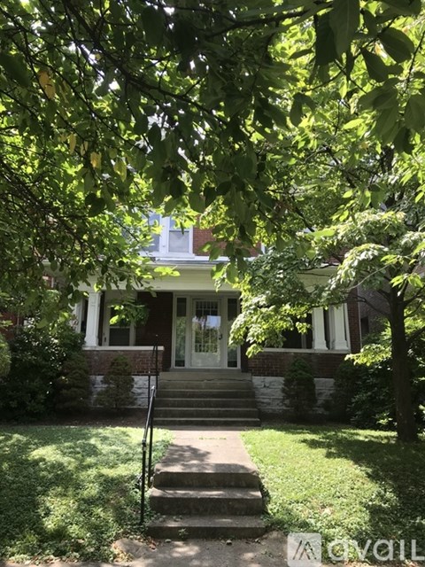 A house with a white front door and a green lawn.