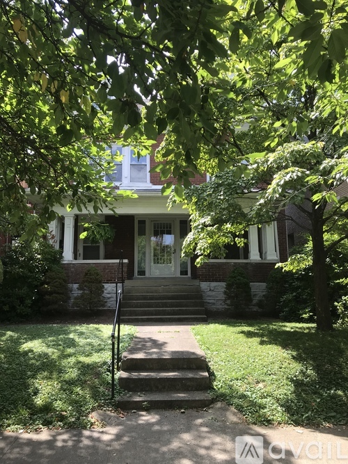 A house with a front porch and steps leading up to it.