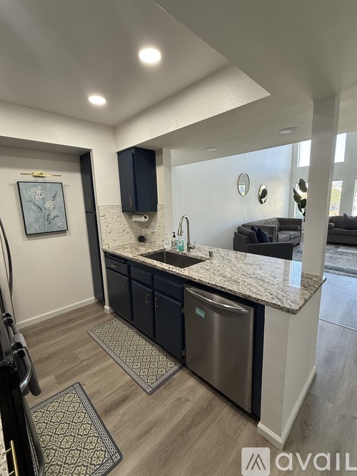 A kitchen with a sink and a blue cabinet.