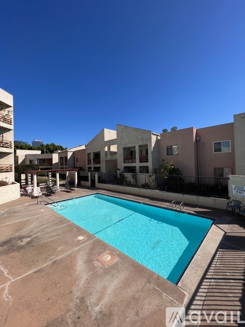 A swimming pool in front of apartment buildings.