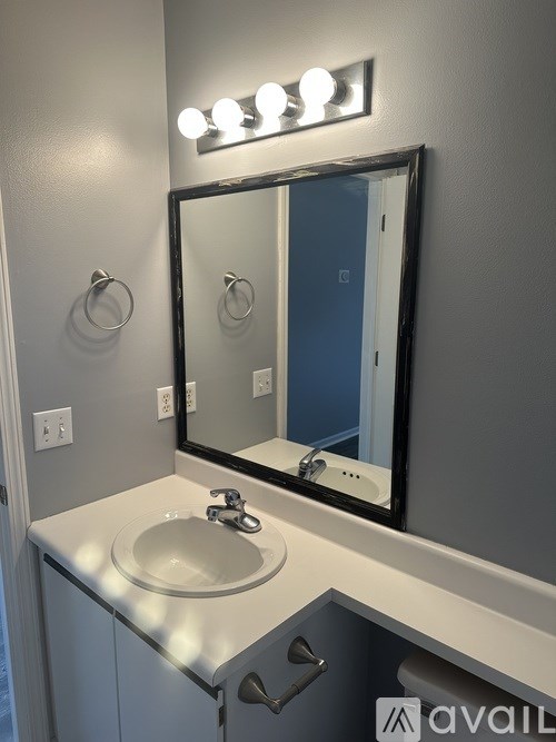 A bathroom with a sink and mirror.