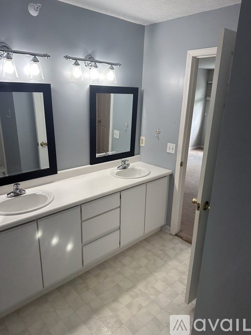 A bathroom with two sinks and two mirrors.