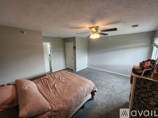 A white toilet in a bathroom with a white shower curtain.