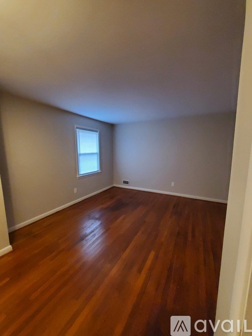 A room with wooden floors and a window.